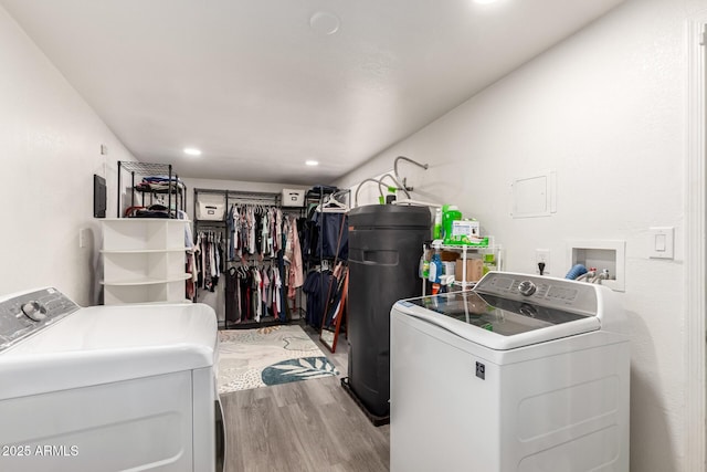 washroom with laundry area, recessed lighting, washing machine and dryer, and light wood-type flooring