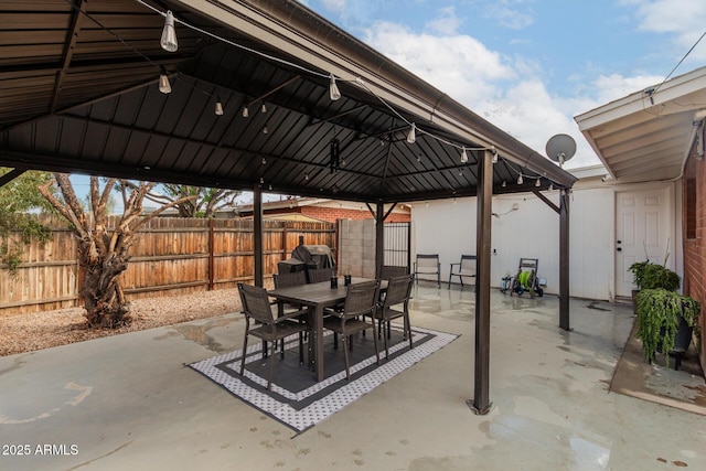 view of patio / terrace with a gazebo, area for grilling, outdoor dining area, and fence