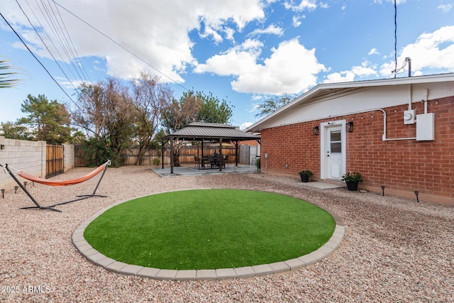 view of yard with a gazebo, a fenced backyard, and a patio