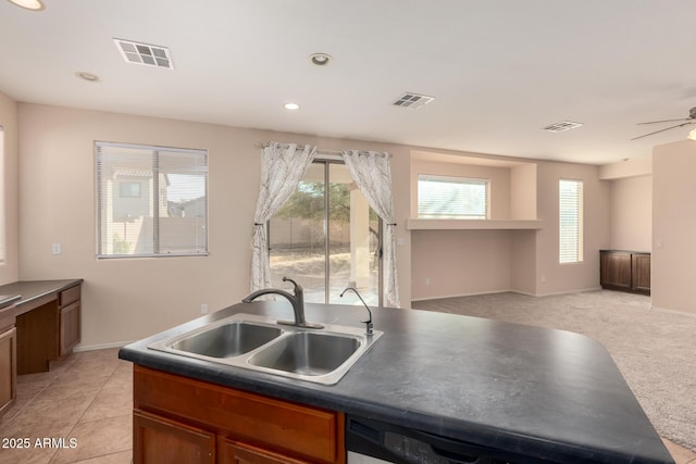 kitchen with light carpet, sink, dishwasher, and ceiling fan