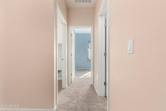 corridor featuring light carpet