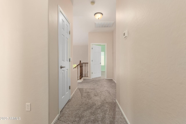 hall featuring light colored carpet