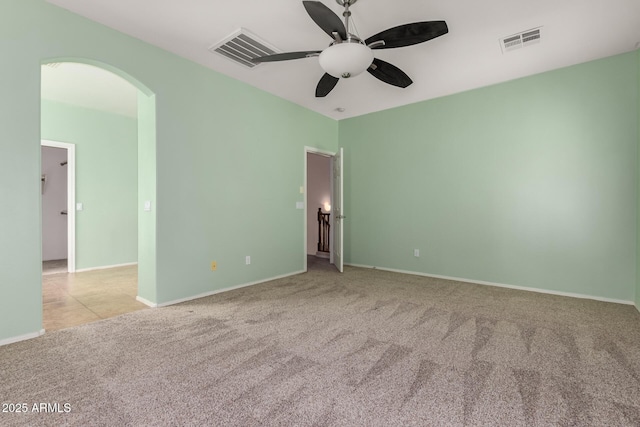 empty room featuring ceiling fan and light colored carpet