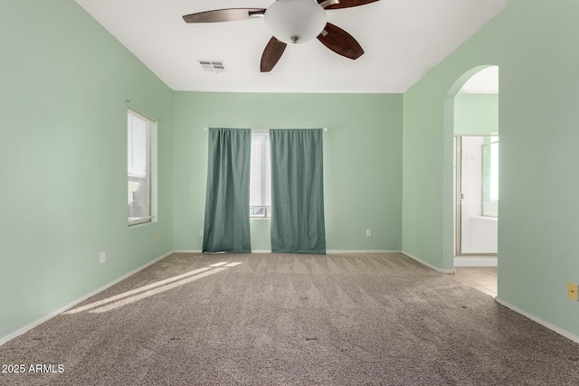 carpeted spare room featuring ceiling fan