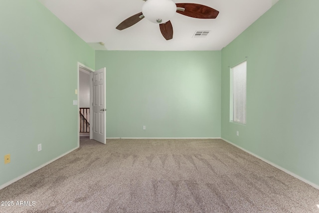 spare room with light colored carpet and ceiling fan