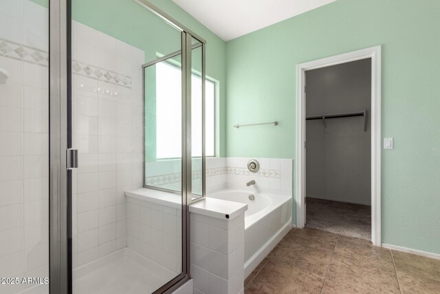 bathroom with independent shower and bath and tile patterned flooring