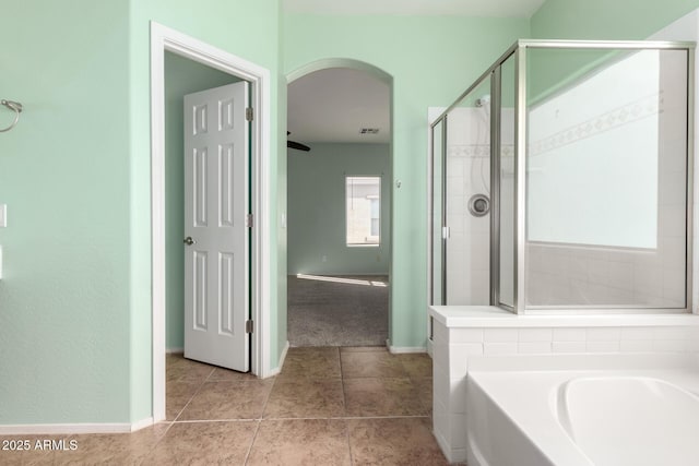 bathroom featuring tile patterned flooring and plus walk in shower