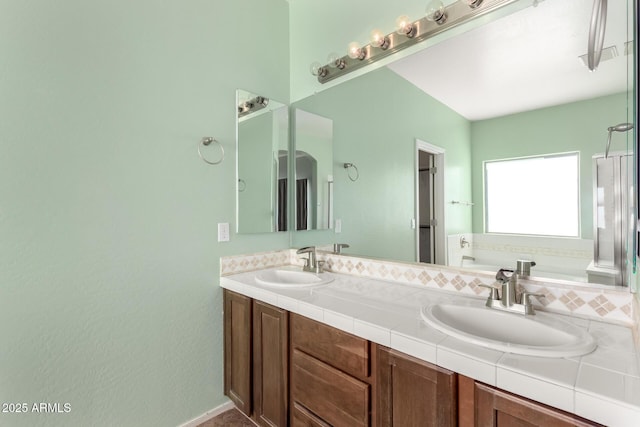 bathroom featuring vanity and a tub