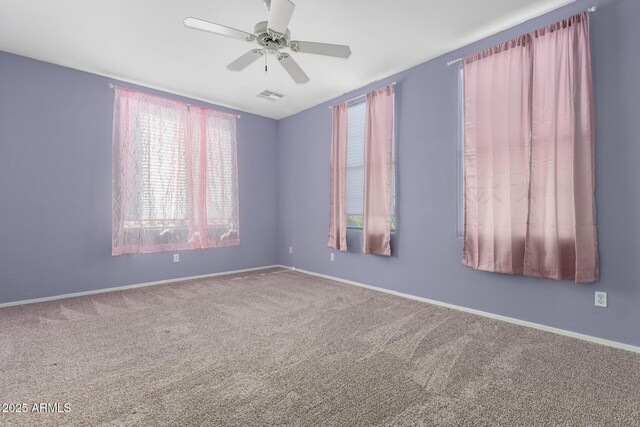 empty room with ceiling fan and carpet