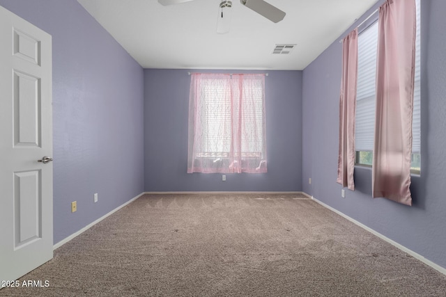 empty room with ceiling fan and carpet