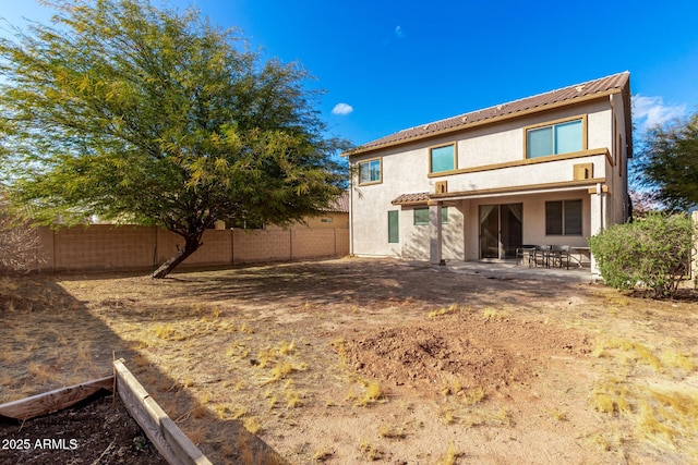 back of property with a patio area