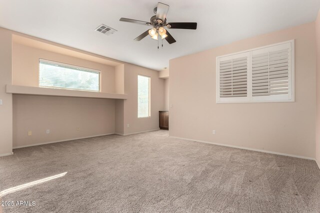 unfurnished room featuring light carpet and ceiling fan