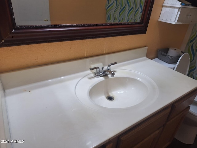 bathroom featuring vanity and toilet