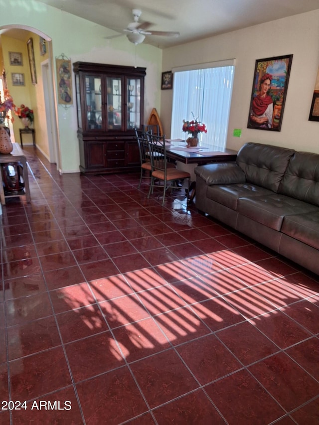 tiled living room with ceiling fan and a healthy amount of sunlight