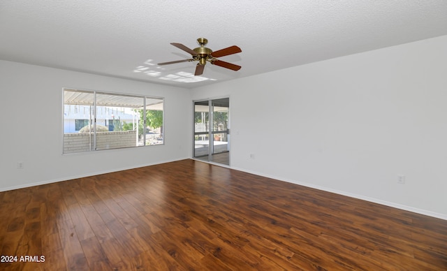 empty room featuring ceiling fan, wood-type flooring, and a textured ceiling