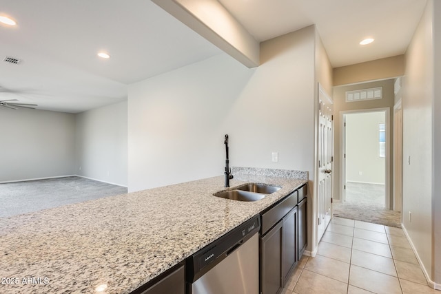 kitchen featuring light stone countertops, dishwasher, sink, ceiling fan, and light colored carpet