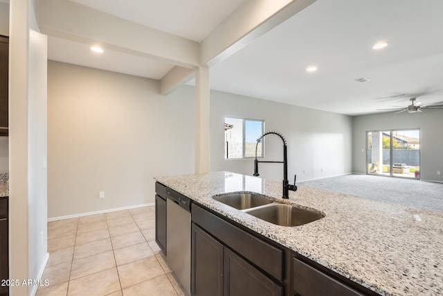 kitchen featuring light stone countertops, ceiling fan, dishwasher, and sink