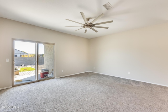 carpeted spare room featuring ceiling fan