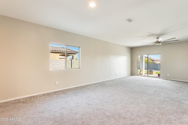 carpeted spare room with ceiling fan