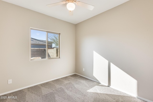 carpeted empty room featuring ceiling fan