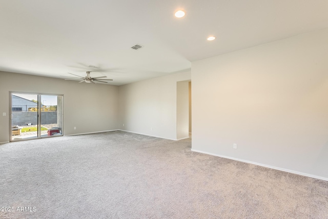 carpeted spare room featuring ceiling fan