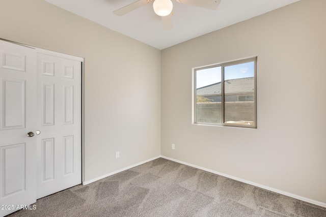 unfurnished bedroom with ceiling fan, carpet flooring, and a closet