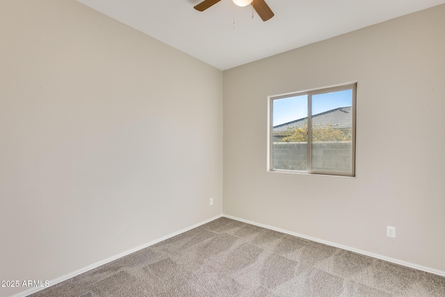 unfurnished room with ceiling fan and carpet