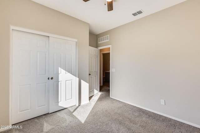 unfurnished bedroom with a closet, carpet flooring, and ceiling fan