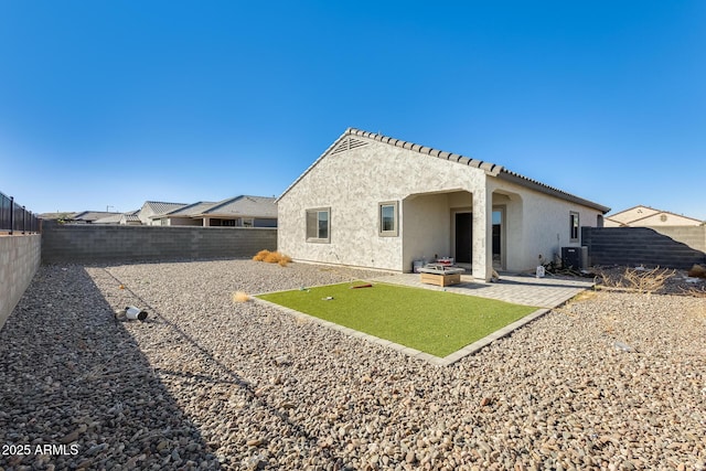 rear view of house with a patio area and cooling unit