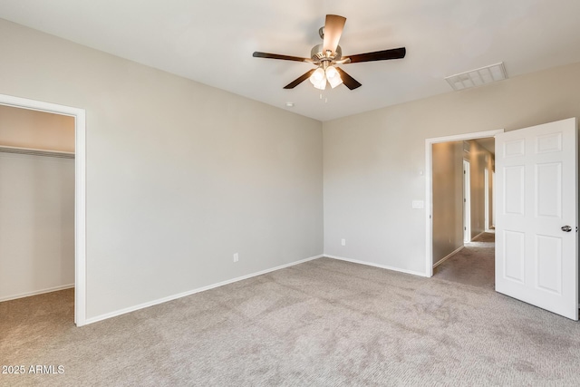 unfurnished bedroom featuring ceiling fan, light colored carpet, and a closet