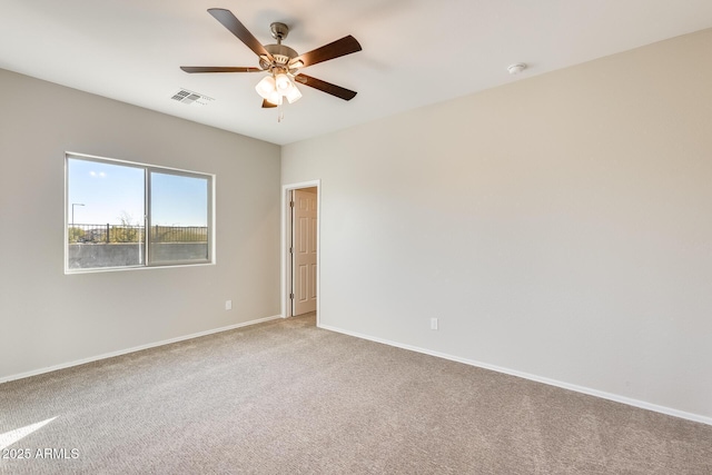 carpeted spare room with ceiling fan