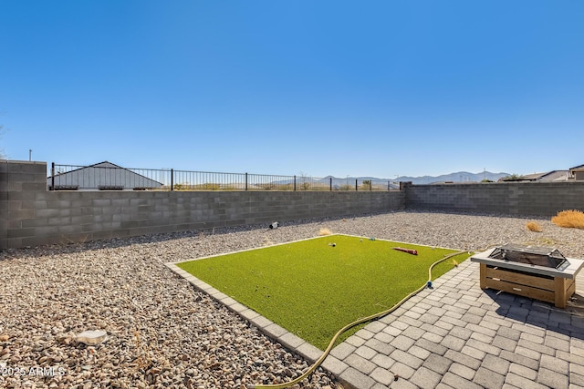 view of yard with an outdoor fire pit and a patio area