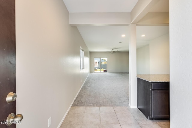 hallway featuring light colored carpet