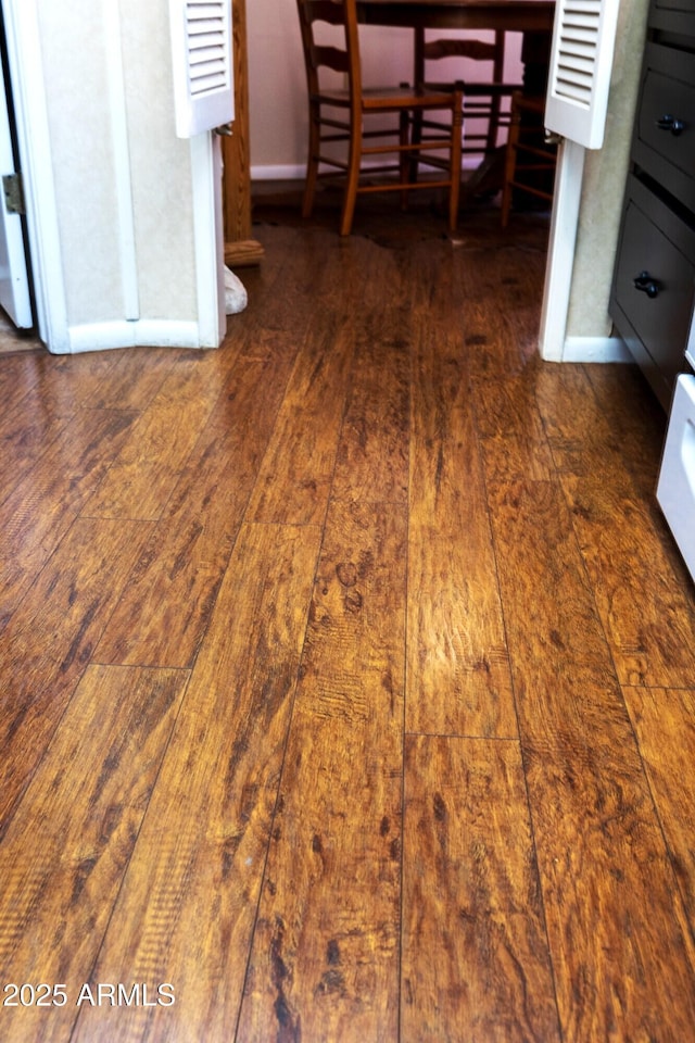 room details featuring baseboards and wood finished floors