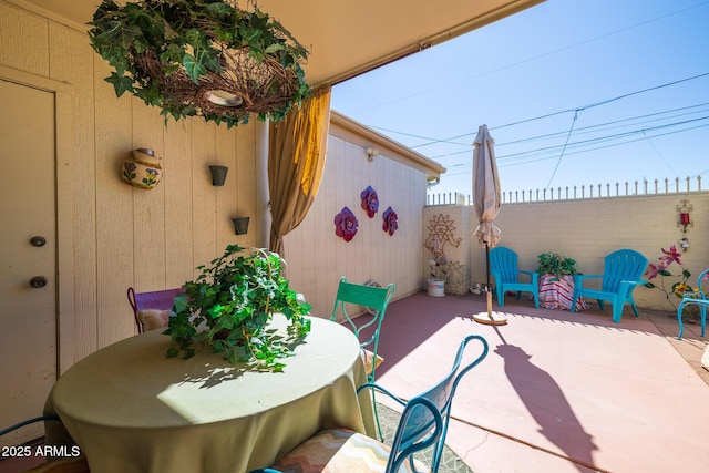 view of patio featuring fence