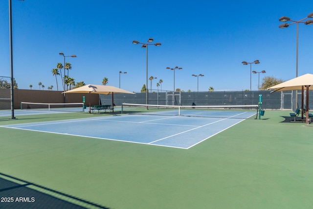 view of sport court featuring fence