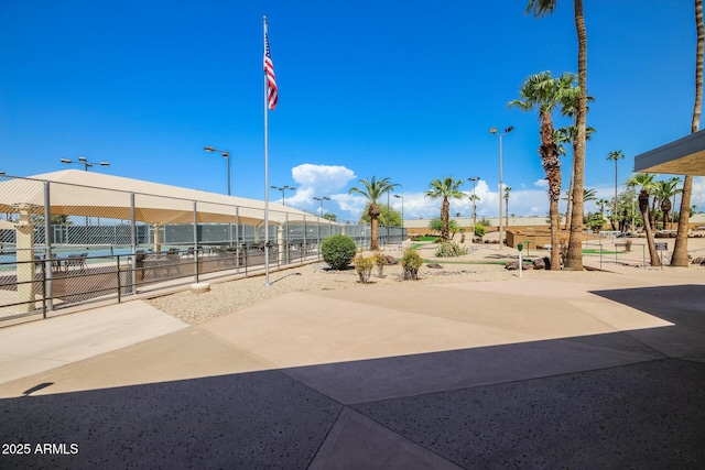 view of home's community featuring fence