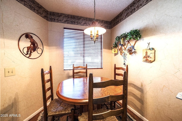 dining area featuring a chandelier and a textured ceiling