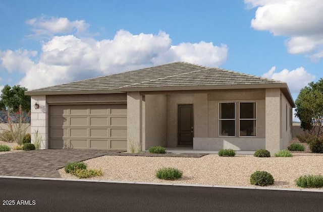 view of front facade with decorative driveway, an attached garage, and stucco siding