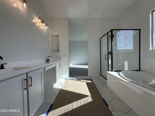 bathroom with a stall shower, tile patterned floors, a sink, and a bath