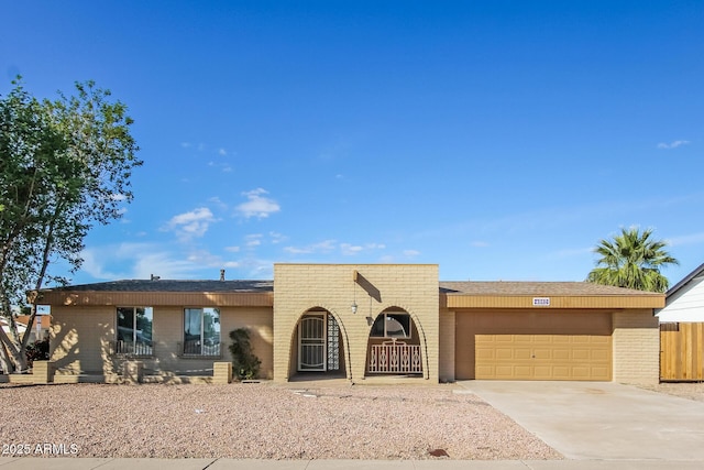 4062 W Eva St, Phoenix, AZ 85051 - view of front of house featuring brick siding, an attached garage, and driveway