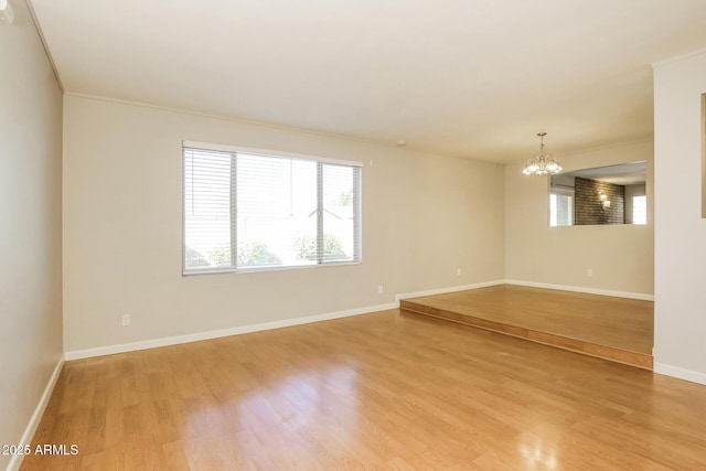 4062 W Eva St, Phoenix, AZ 85051 - spare room with a chandelier, light wood-style flooring, and baseboards