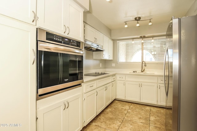 4062 W Eva St, Phoenix, AZ 85051 - kitchen featuring stainless steel appliances, a sink, under cabinet range hood, white cabinets, and light countertops