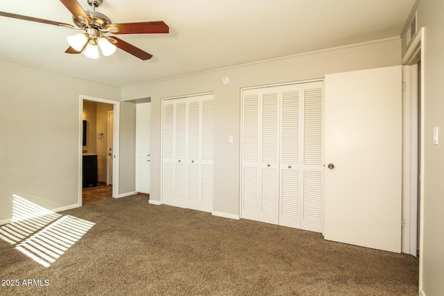 4062 W Eva St, Phoenix, AZ 85051 - unfurnished bedroom with two closets, carpet floors, a ceiling fan, and baseboards