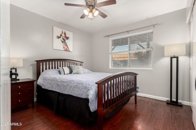 bedroom featuring a ceiling fan, baseboards, and wood finished floors