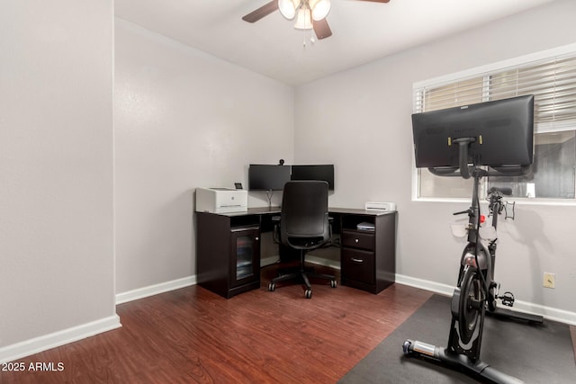 home office featuring a ceiling fan, baseboards, and wood finished floors