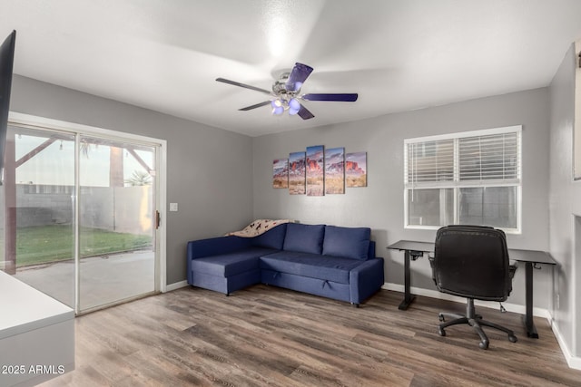 office space featuring wood finished floors, a ceiling fan, and baseboards