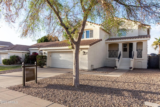 mediterranean / spanish house with an attached garage, covered porch, a tile roof, driveway, and stucco siding