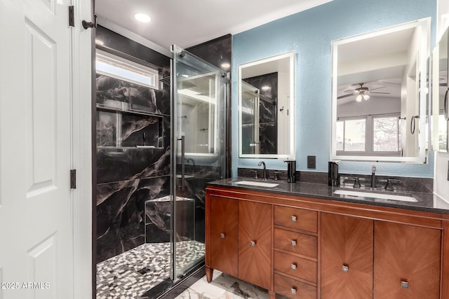 bathroom with marble finish floor, double vanity, a sink, and a shower stall