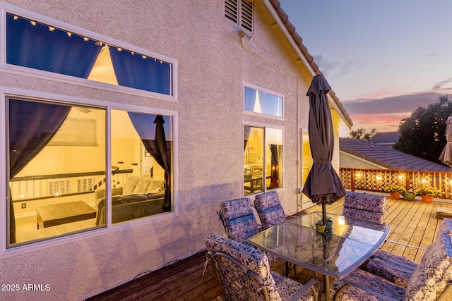 exterior space featuring a deck and outdoor dining area